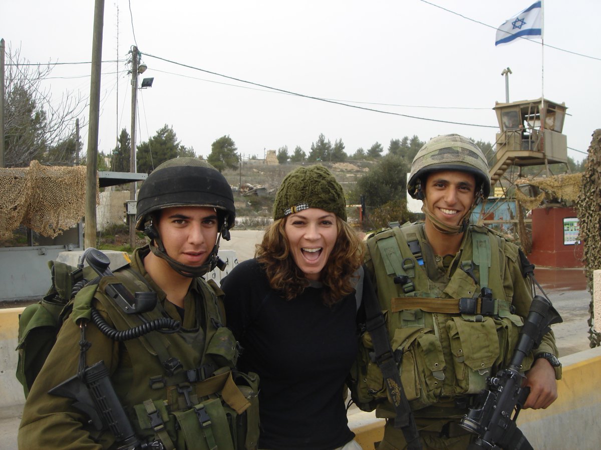 Rachael in the West Bank in 2006, photographed between two young armed soldiers